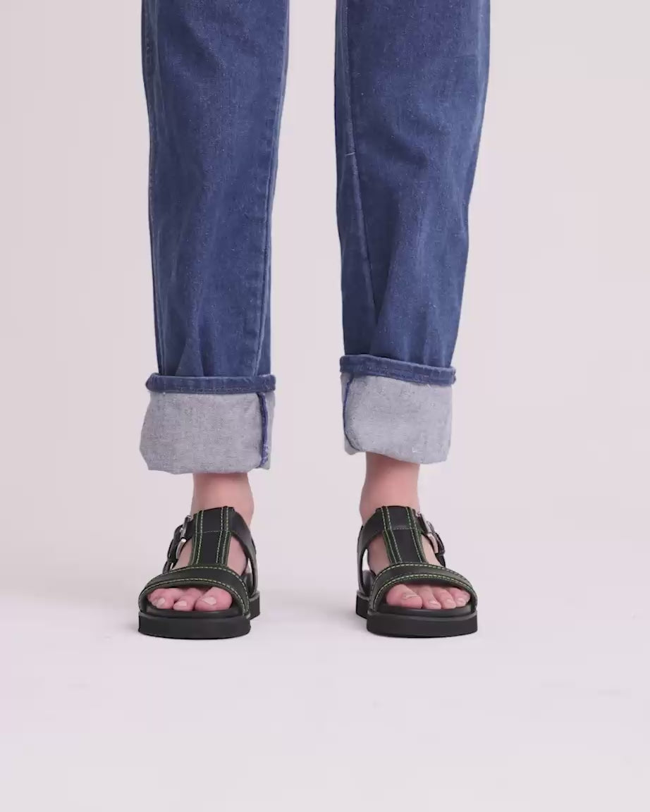 Visby T-Bar Sandal: Black Leather with Green Topstitch