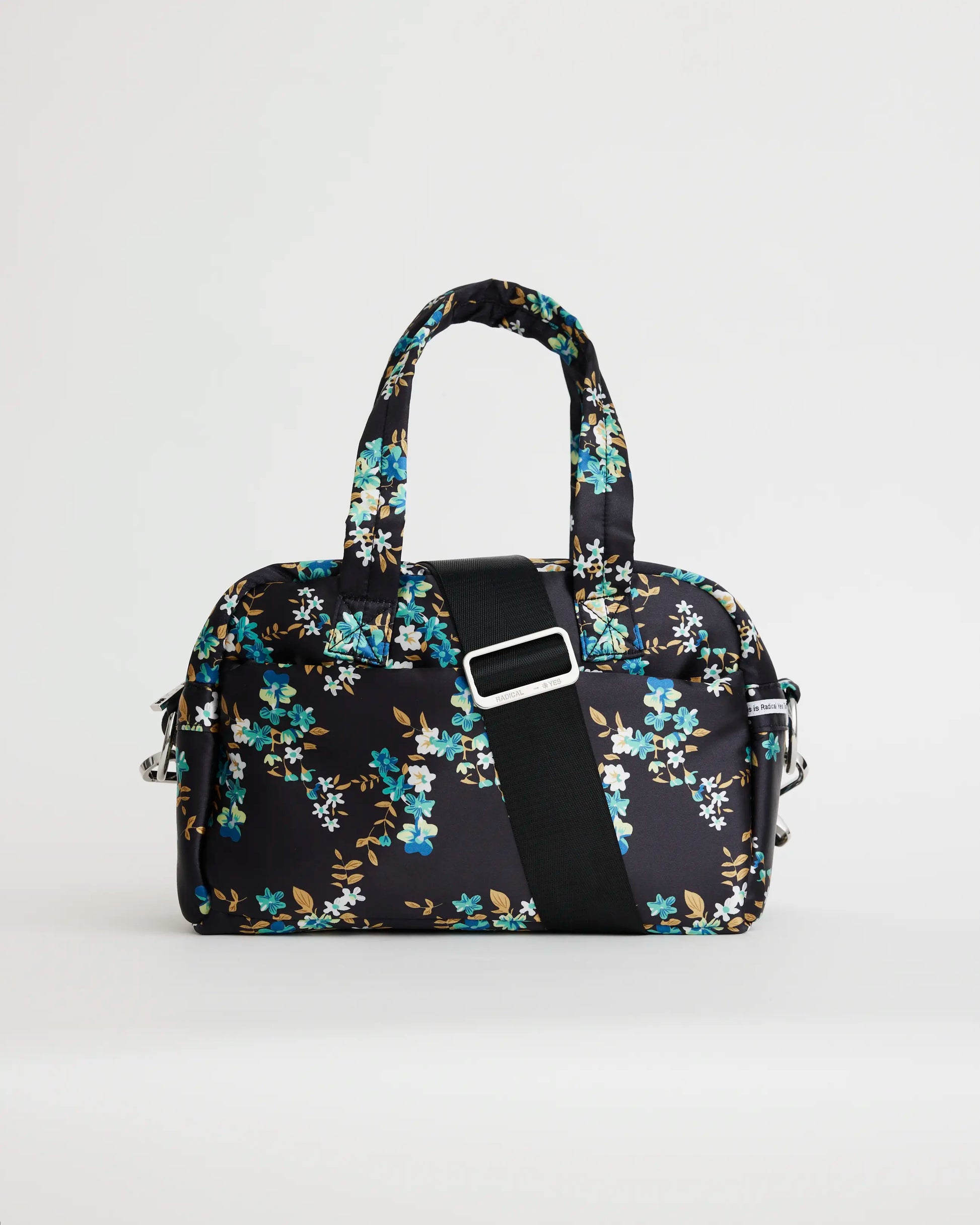 Floral printed navy bowling bag with a black crossbody strap