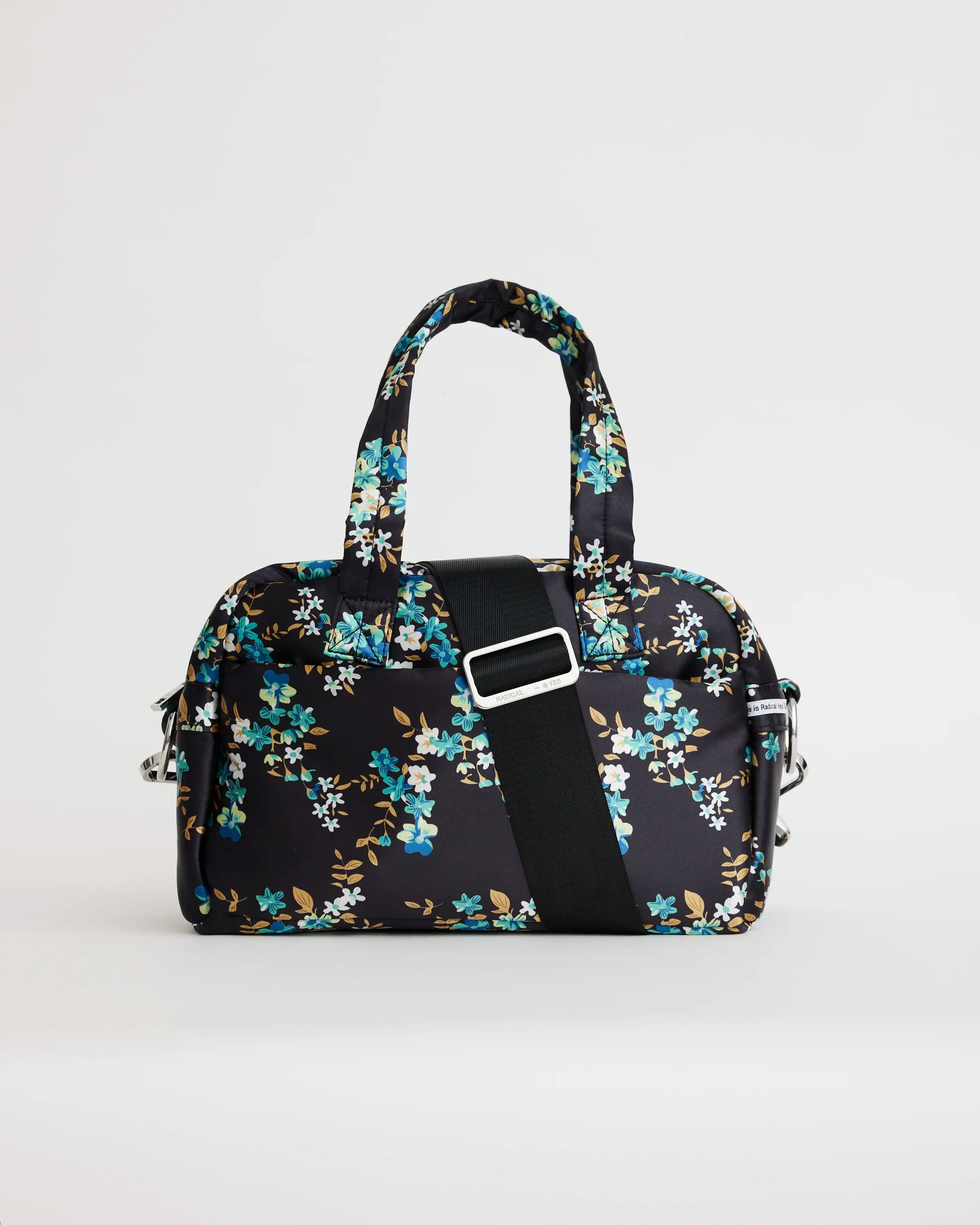 Floral printed navy bowling bag with a black crossbody strap
