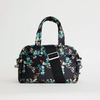 Floral printed navy bowling bag with a black crossbody strap