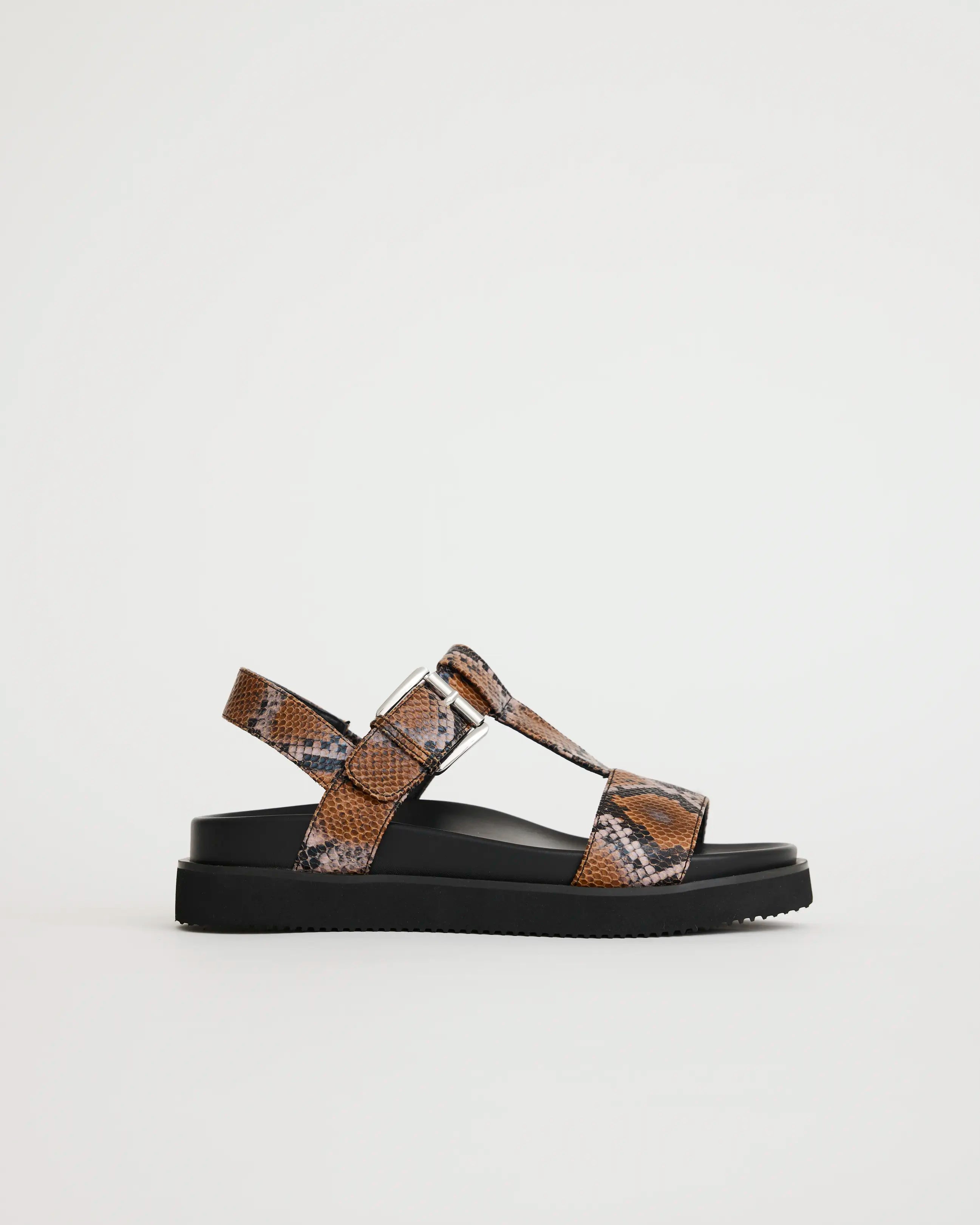 Arch support T-bar sandal with caramel snake print straps on a light gray background