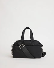 Black nylon bowling bag with a shoulder strap on a light gray background