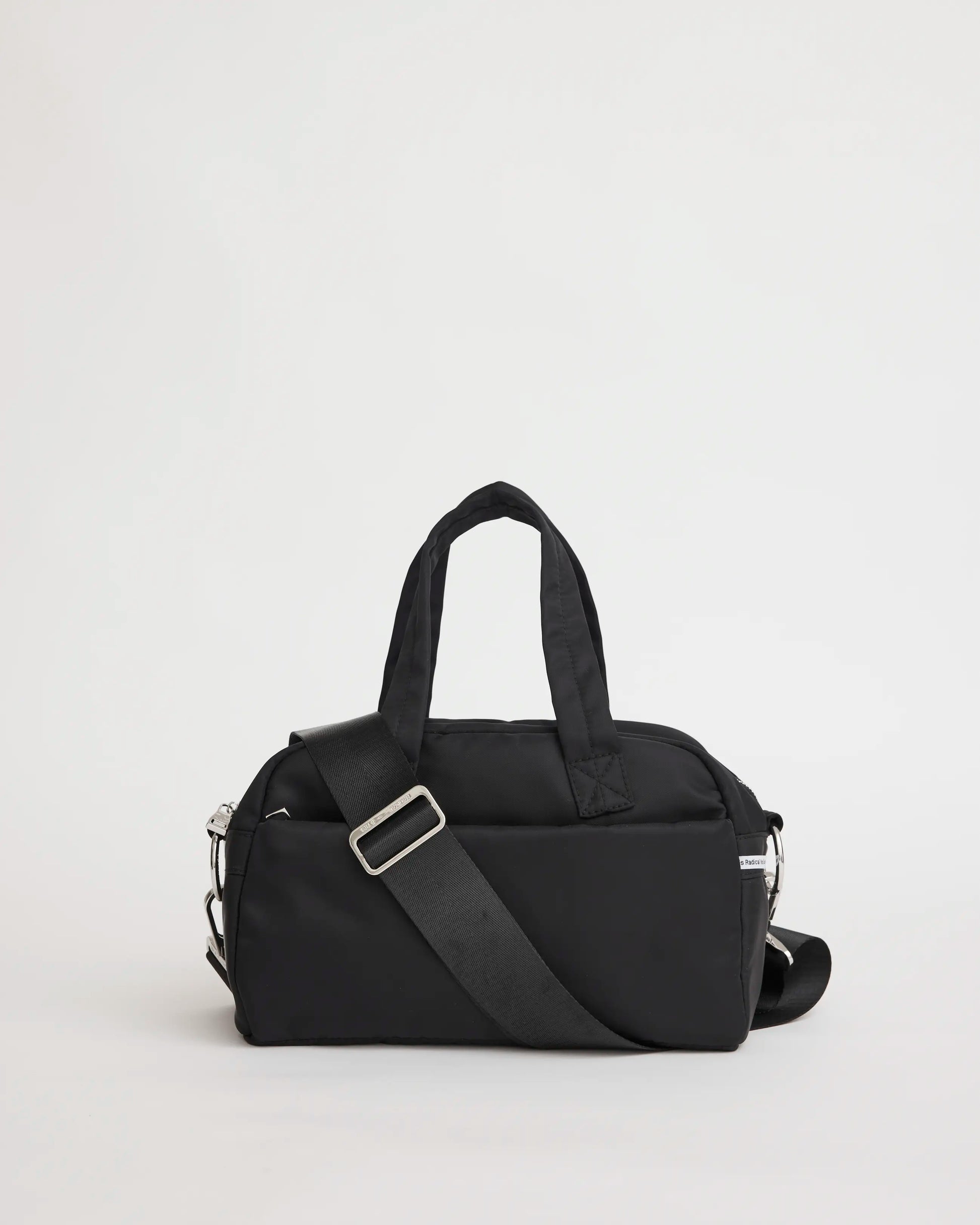 Black nylon bowling bag with a shoulder strap on a light gray background