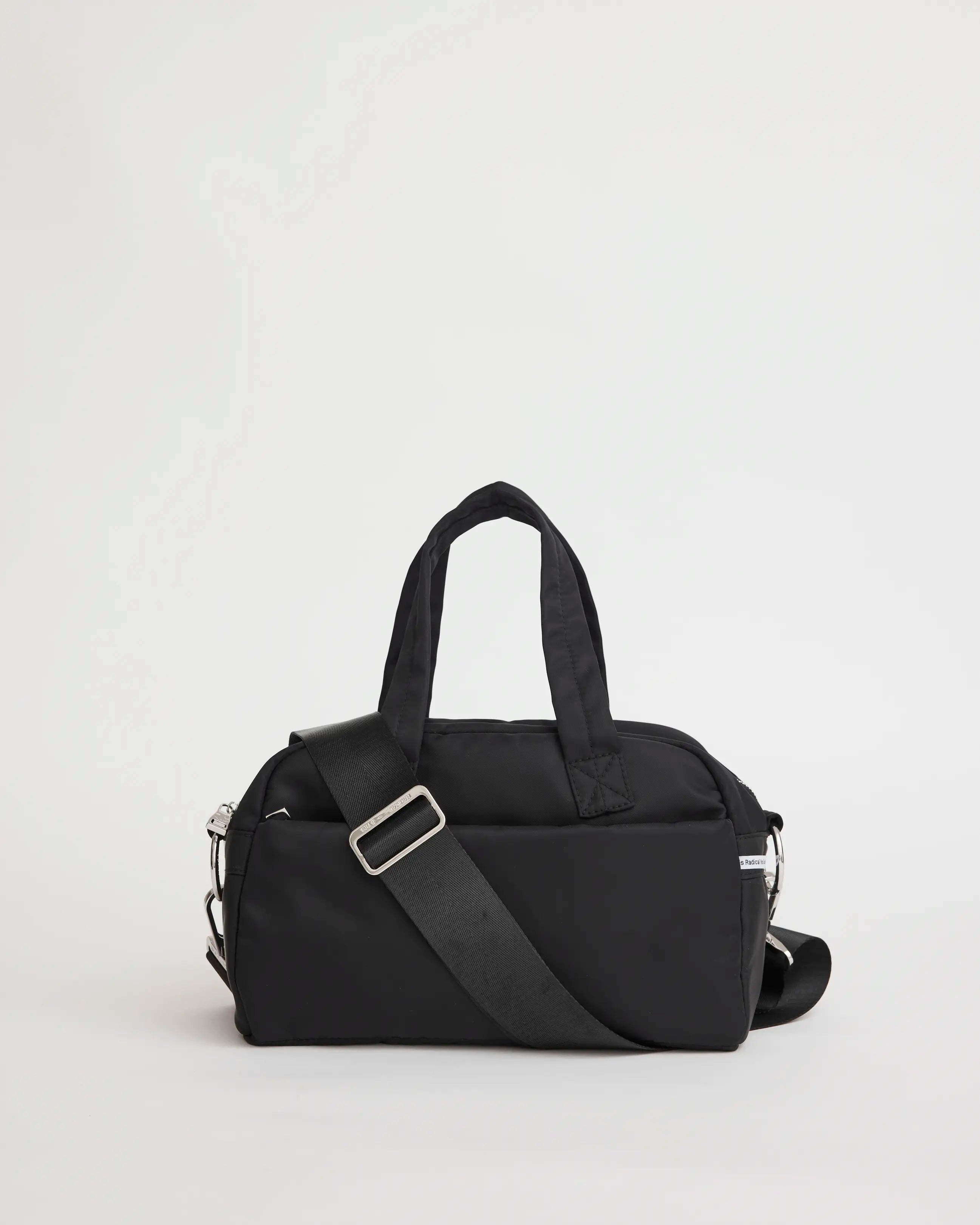 Black nylon bowling bag with a shoulder strap on a light gray background