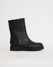 Black leather wool lined boot on a light gray background