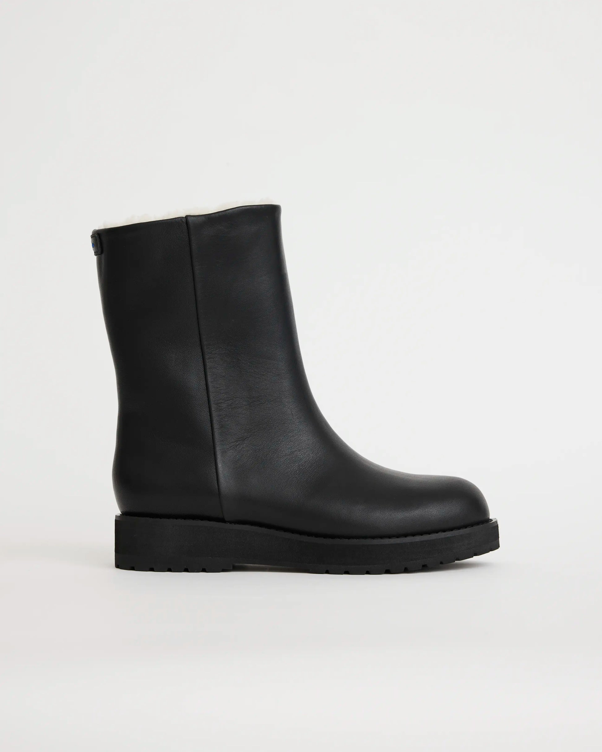 Black leather wool lined boot on a light gray background