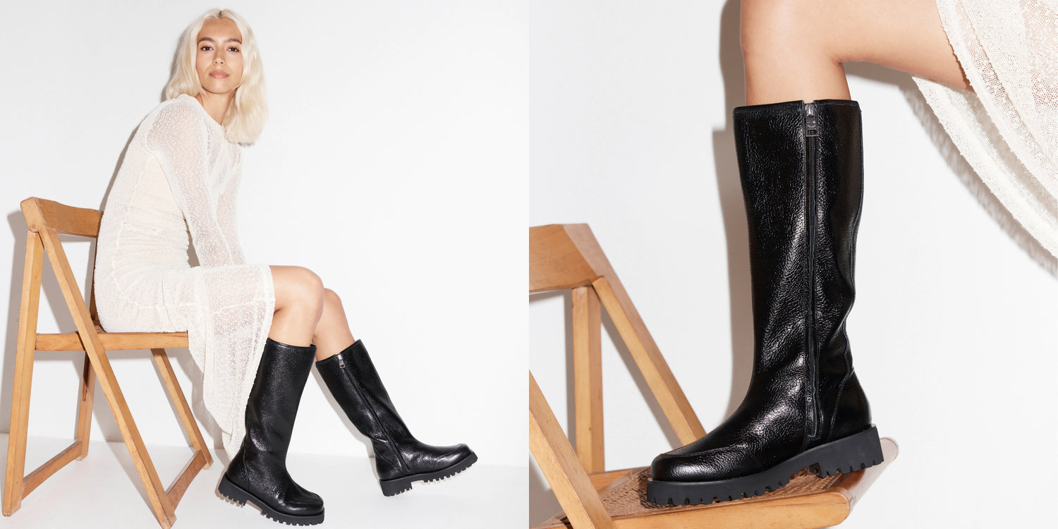 Person wearing back leather knee high boots with a white dress