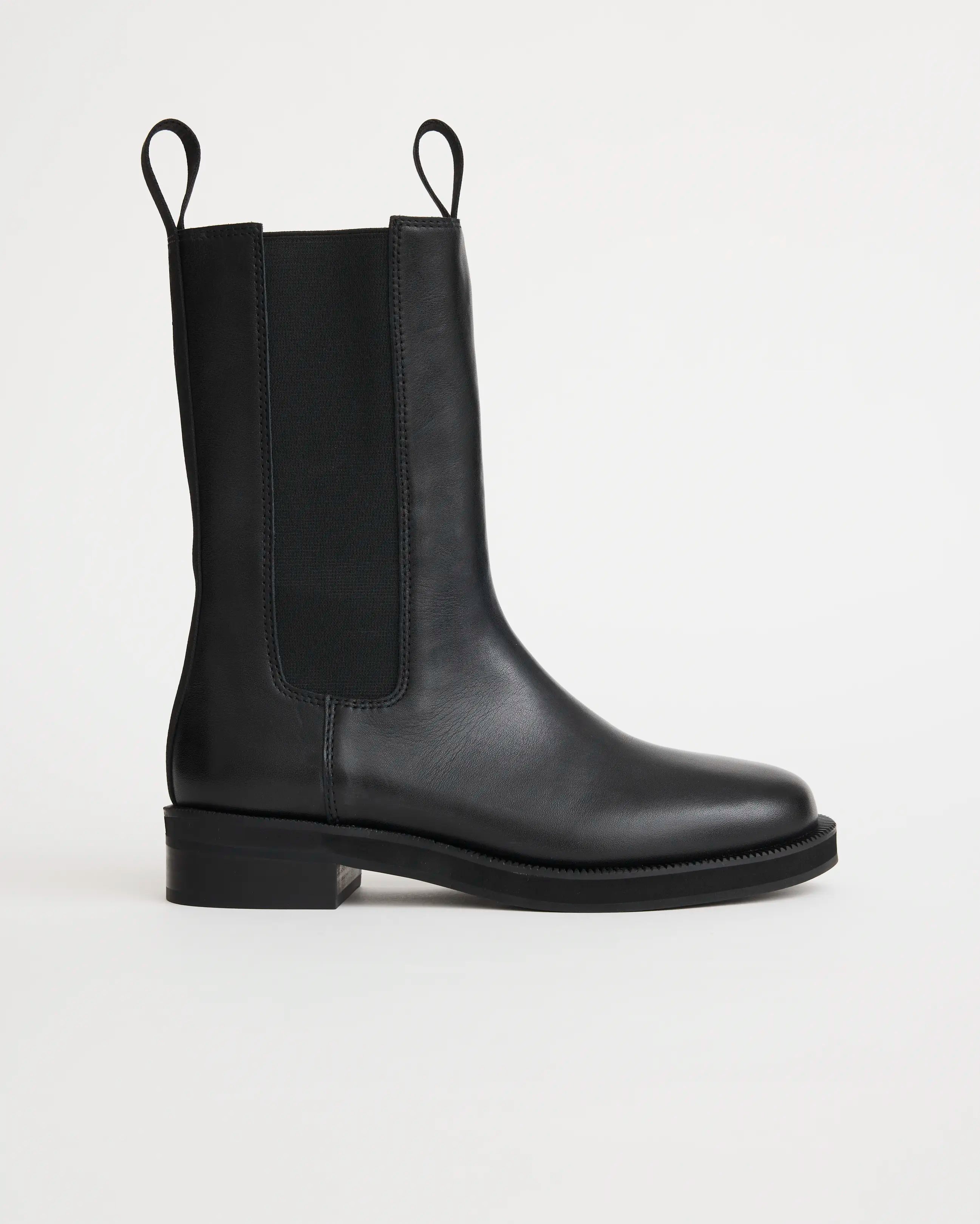 Black leather riding boots against a white background.