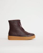 Purple leather zip front ankle boot with a tan sole