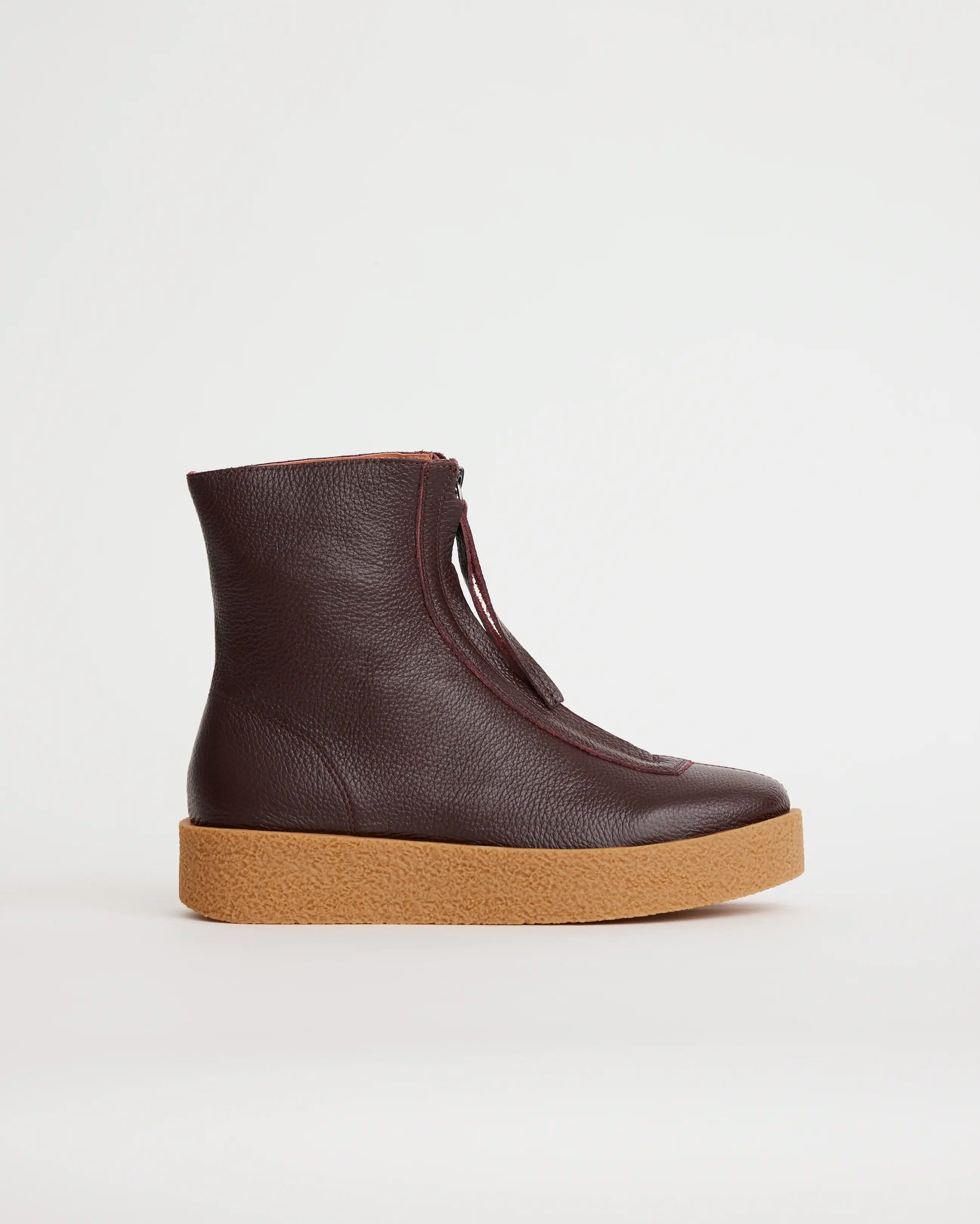 Purple leather zip front ankle boot with a tan sole