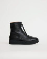 Black leather zip up ankle boot on a light gray background