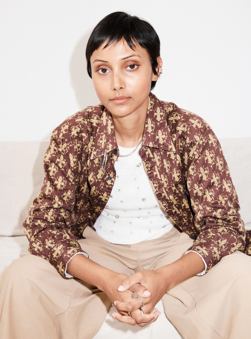 Close up shot of a model wearing a printed jacket.
