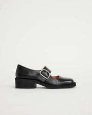 Black leather square-toe Mary Jane shoe with a buckle on a light grey background