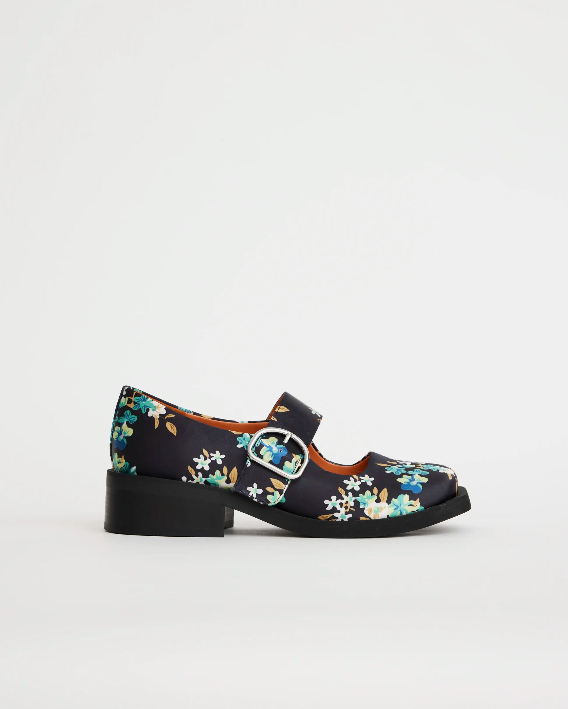 Floral-patterned square toe shoe with a buckle on a light gray background