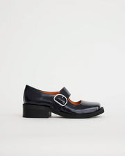 Glossy navy leather square toe shoe with silver buckle on a white background