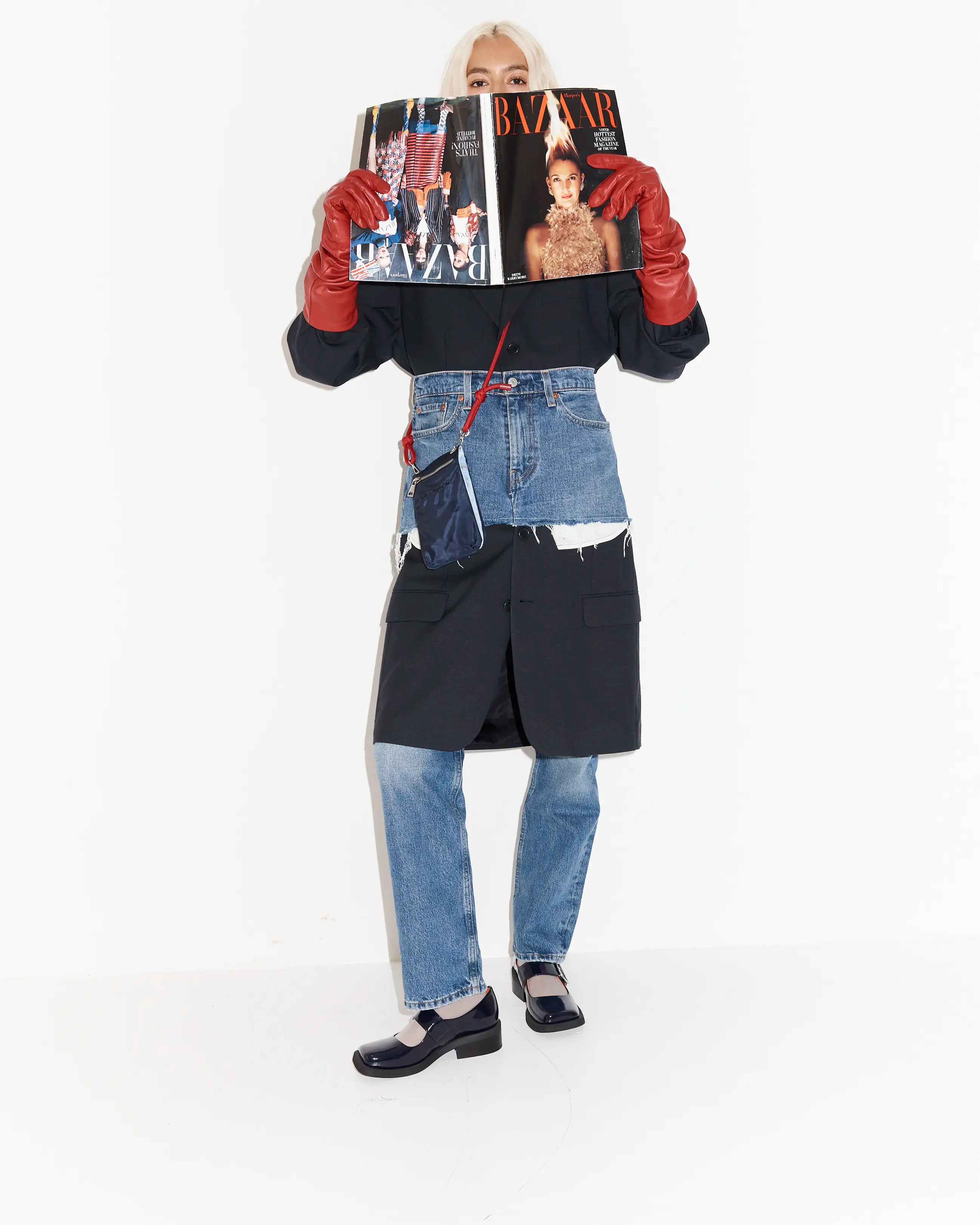 Person wearing a denim outfit with glossy navy square toe leather shoes