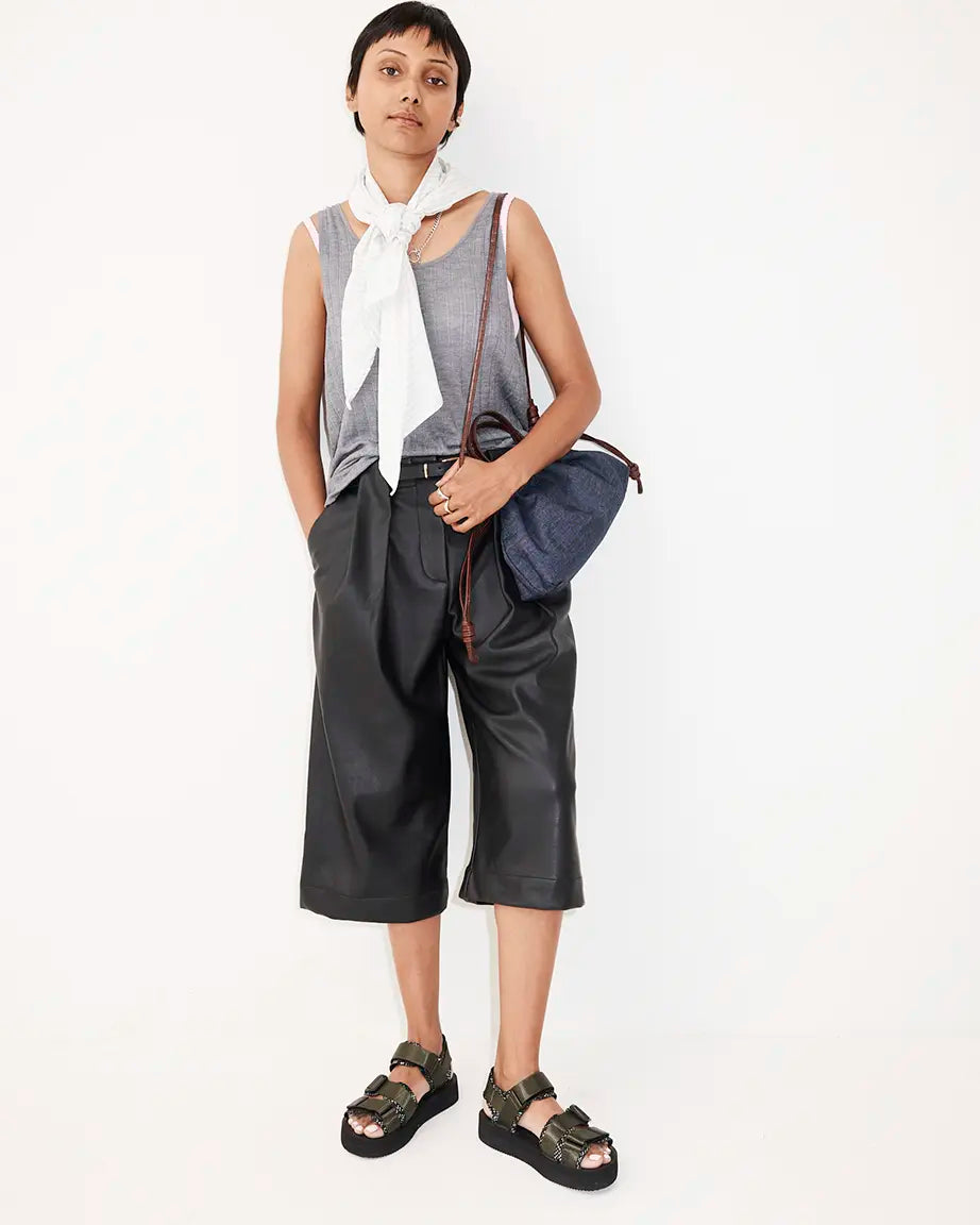 A model wearing a sleeveless gray top with olive green nylon sandals.