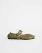 Green leather flat shoe with a silver buckle on a white background