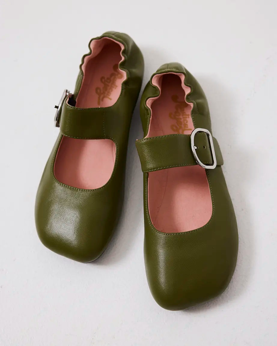 Pair of green leather flat shoes with a silver buckle on a white background
