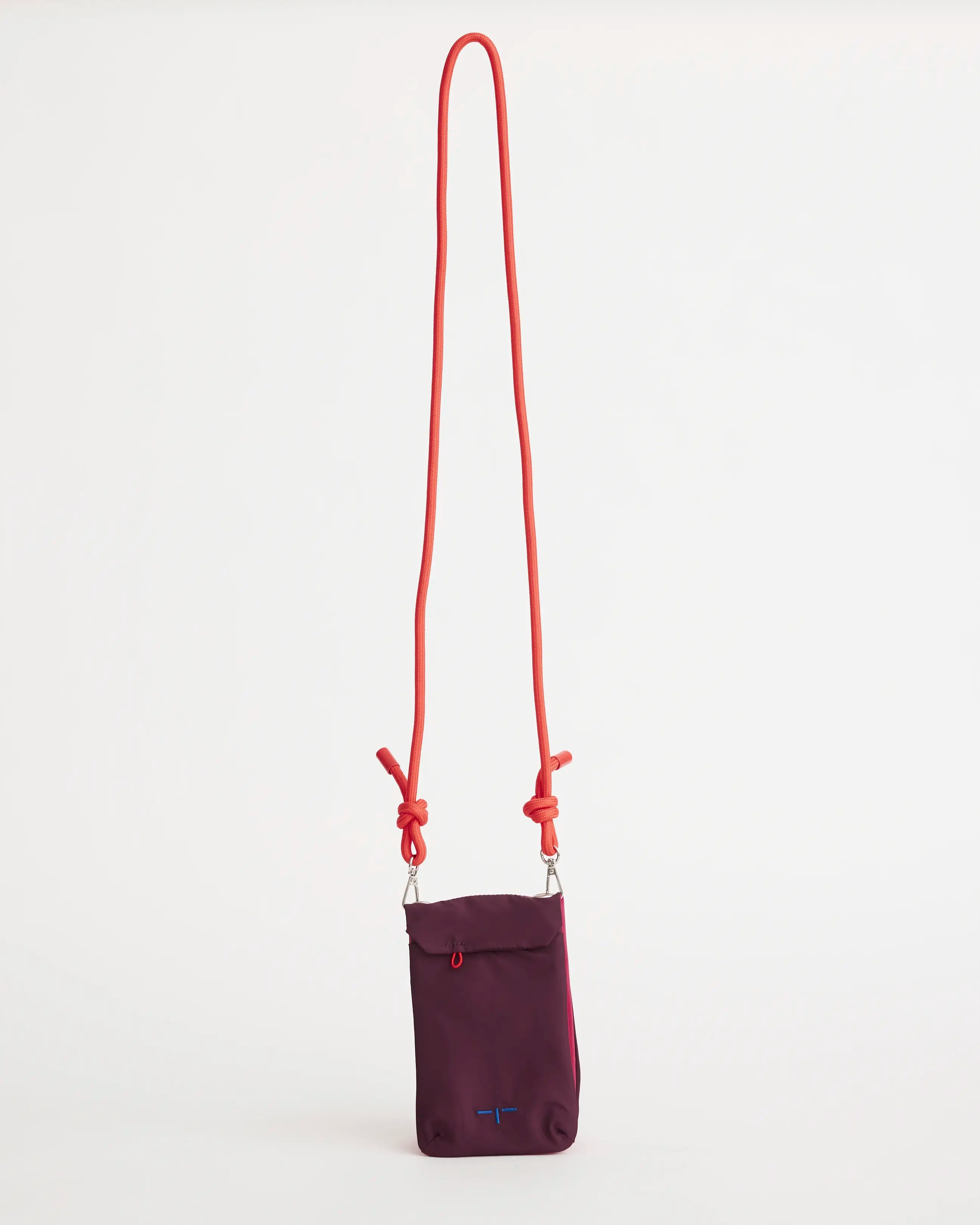 Purple pouch with an orange strap on a white background