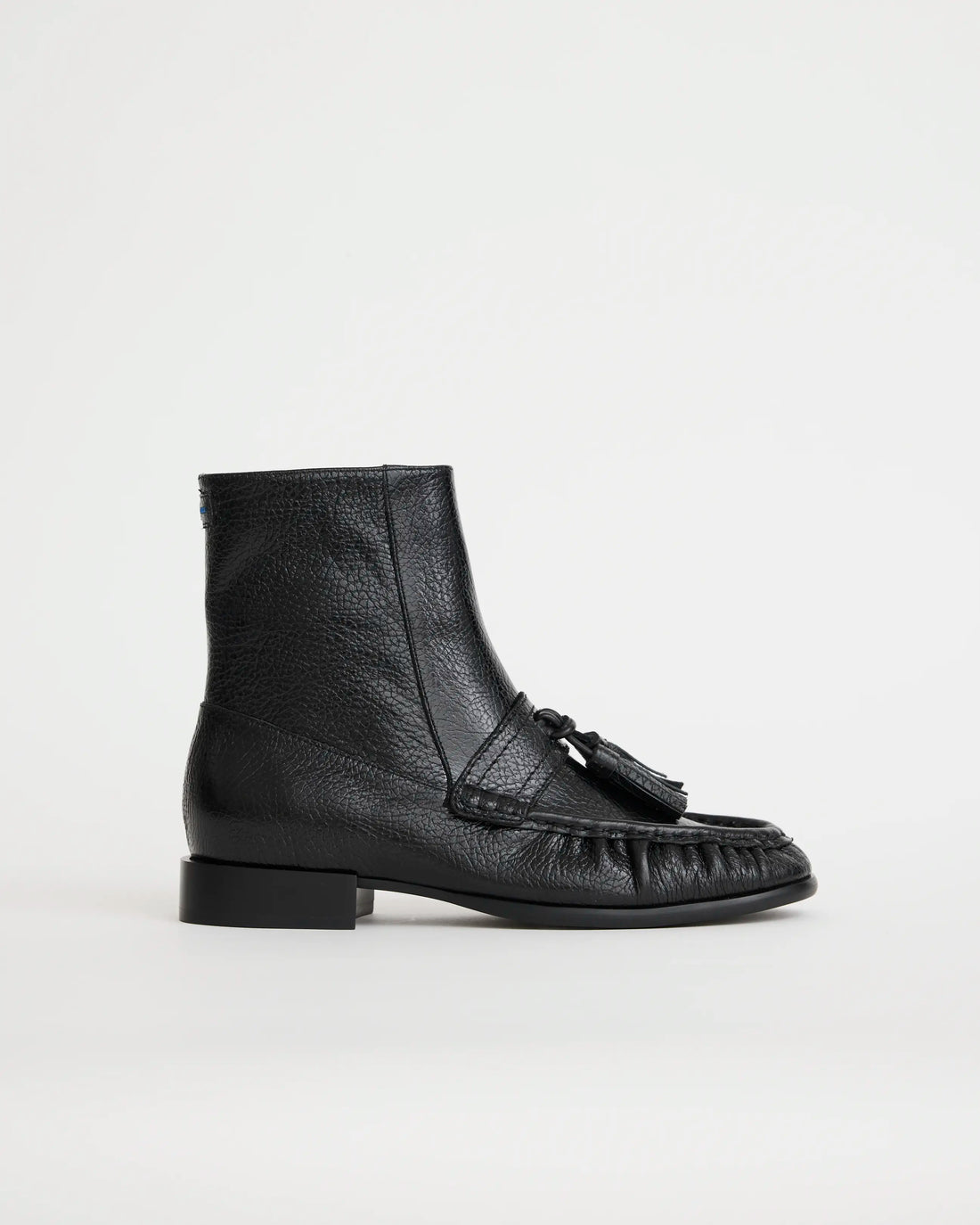 Black leather boot with tassel on a white background
