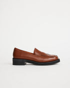 Brown leather loafers on a white background