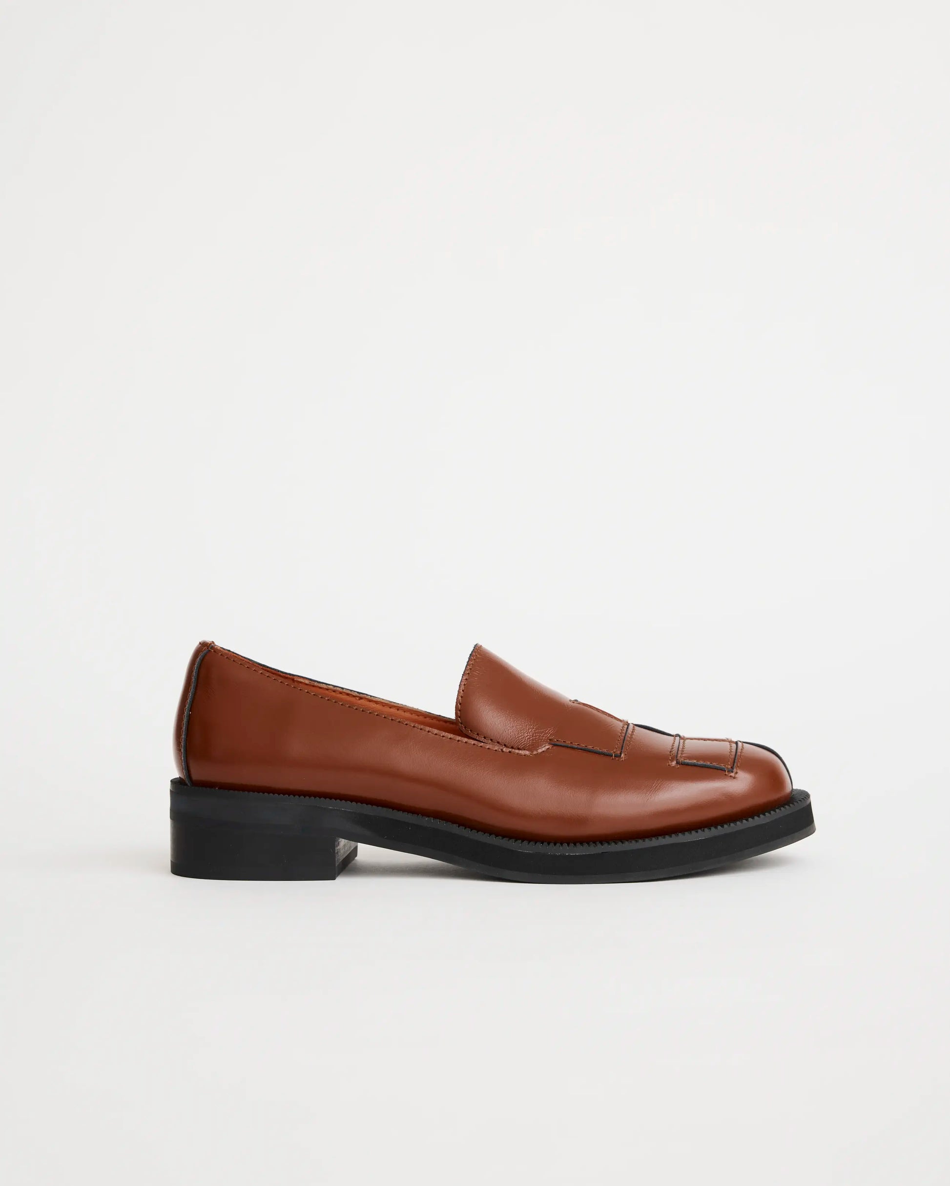 Brown leather loafers on a white background