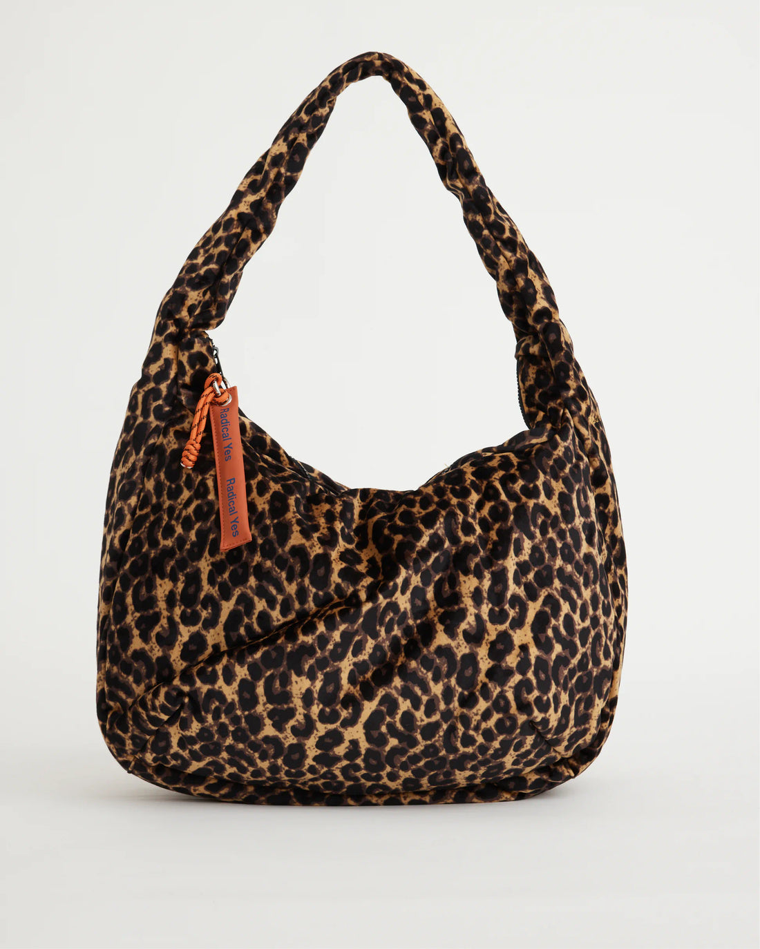 Leopard print handbag with a visible brand tag on a light gray background