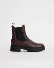 Purple leather Chelsea boot on a white background