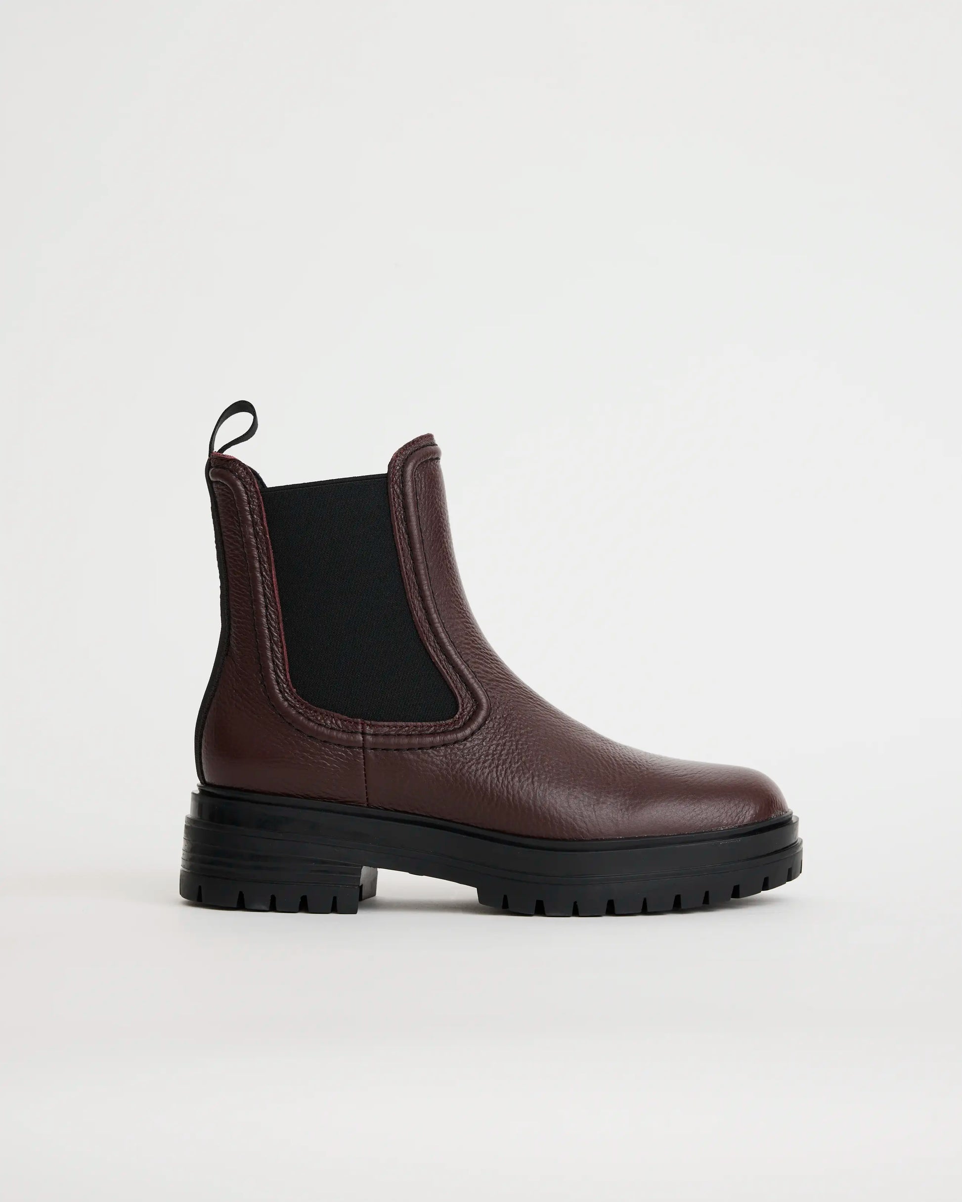 Purple leather Chelsea boot on a white background