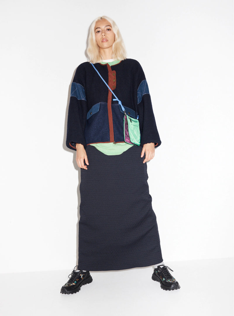 Person wearing a navy outfit with floral printed chunky sneakers