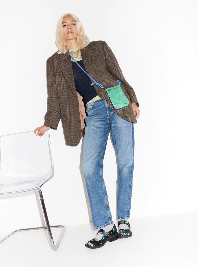 Person wearing denim with floral printed square toe mary janes