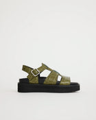 Green leather croc-patterned sandal with platform sole on a white background