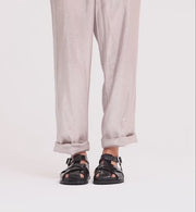 Person wearing black patent leather sandals with arch support