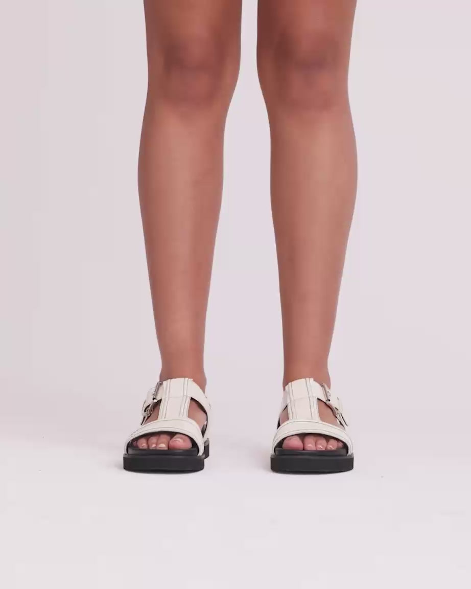 Load video: Visby T-Bar Sandal | Milk with Black Topstitch