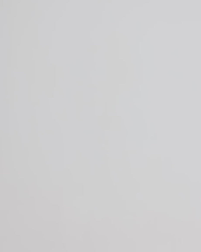 Person walking in the frame with a purple phone pouch and a crossbody orange strap.